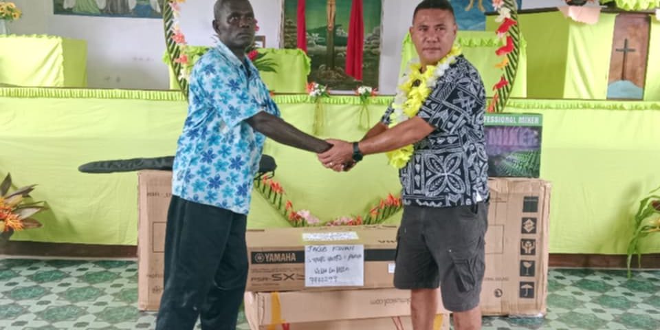 Jacob Kwan handing over the Musical Instrumental to UN Pastor Dido at the Supato Church in South Vella WP