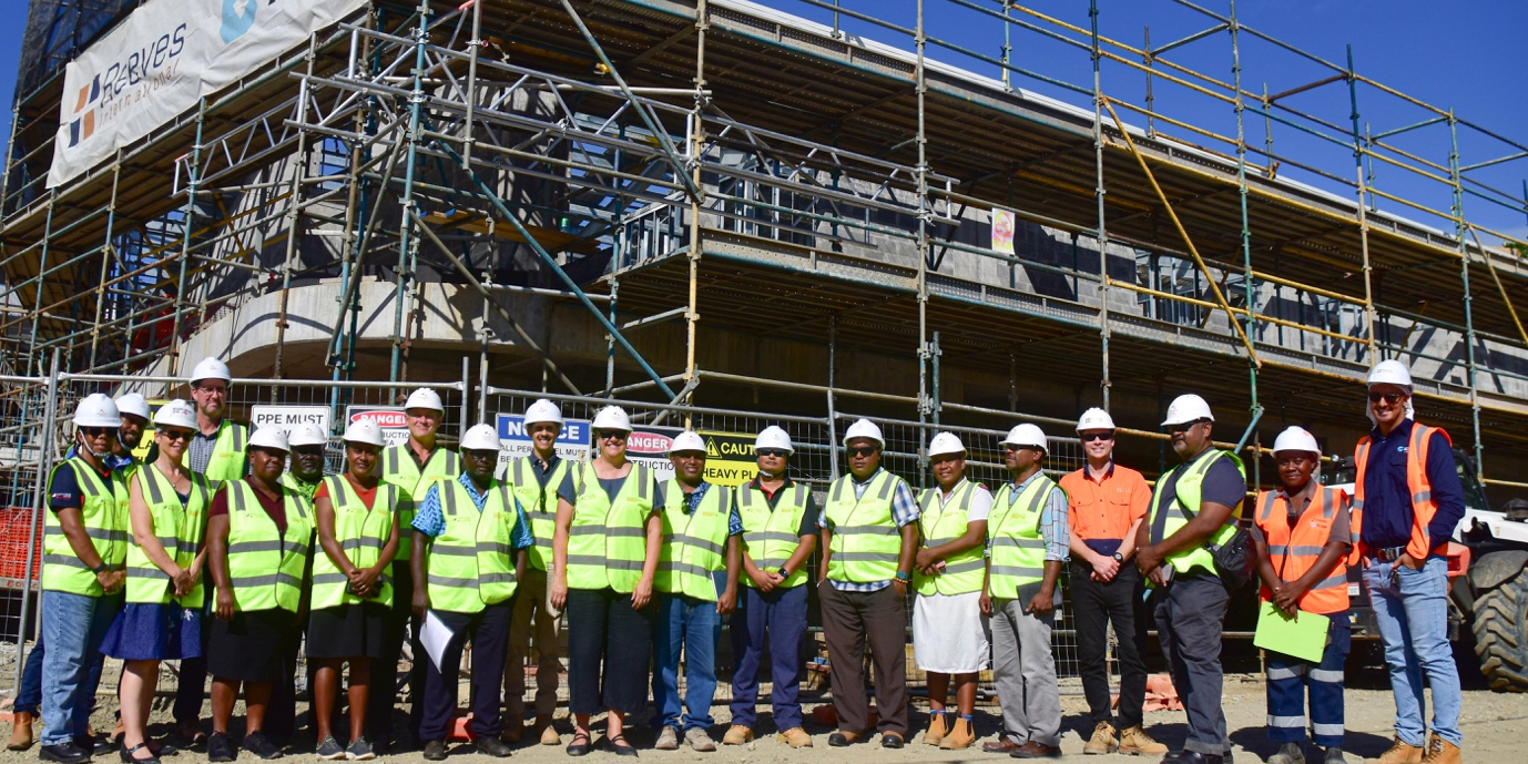 Health officials and workers at the site of the new Naha Birthing and Urban Health Centre