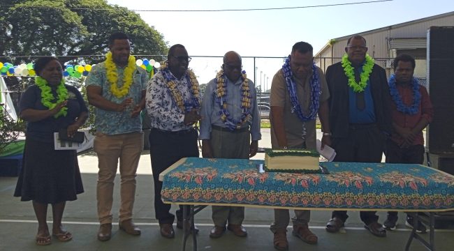 MCILI Minister, Jamie Vokia (3rd from right) cutting the celebration cake while officials look on.