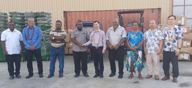 Officials pose after the handing over ceremony