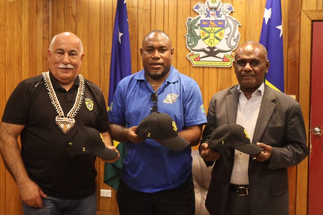 PM Manele (R), President of SIFF, Donald Marahare (C) and Wynnum Wolves President, Rabieh Krayem displaying one of the many merchandises of the partnership