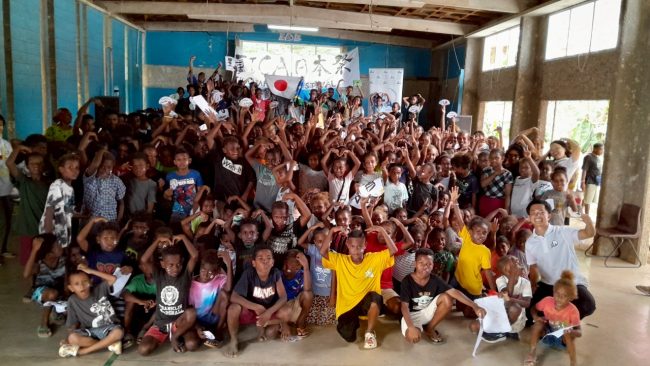 Auki Primary School students pose with Japanese volunteers for a group photo in Auki.