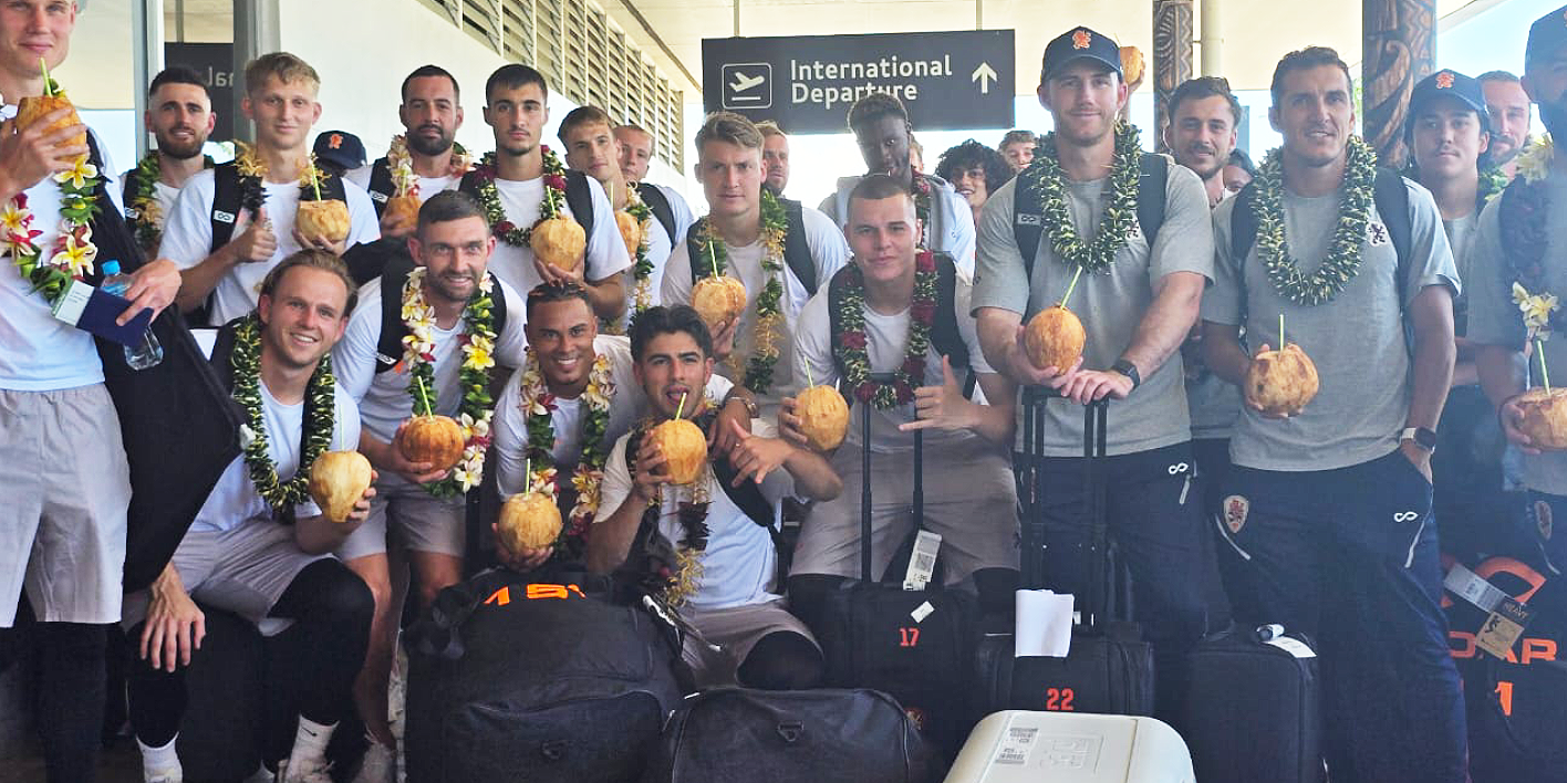 Brisbane Roar team members enjoying green coconuts upon their arrival.