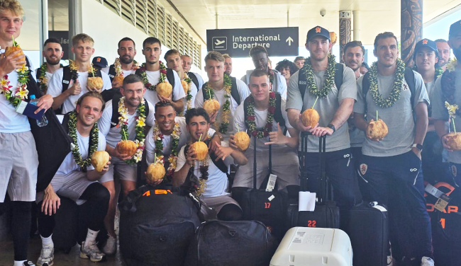 Brisbane Roar team members enjoying green coconuts upon their arrival.