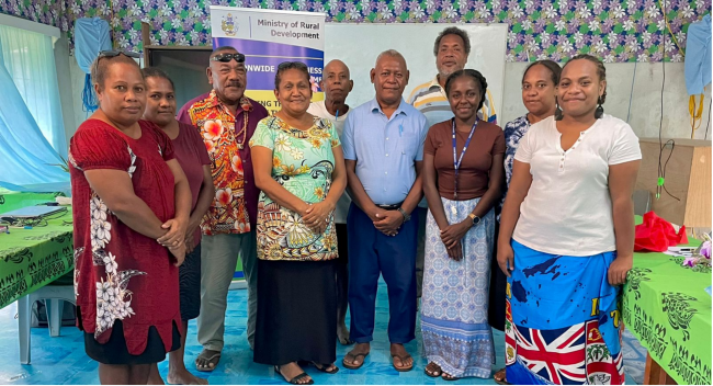 Honourable Minister Cathy Nori, MP (centre front) along with three female MRD legal officers on the right and the Maringe-Kokota Constituency CDC members.