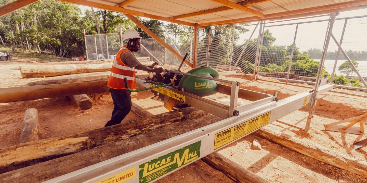 A KFPL worker demonstrating how to mill logs into sawn timber.