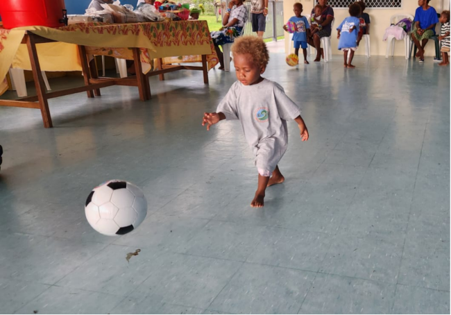 A moment of joy- A child at the CCC plays with a ball donated by RSIPF and RAPPP officers during the community engagement visit.