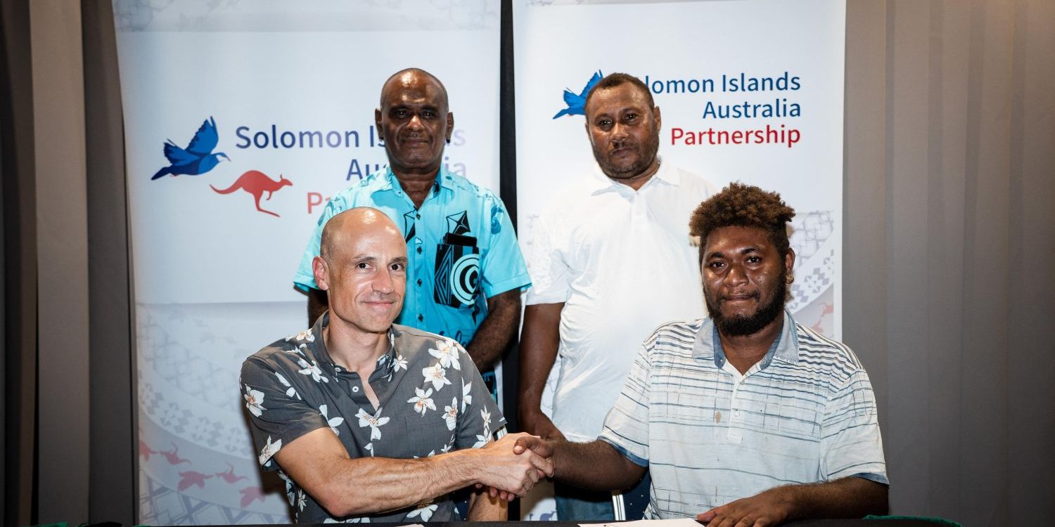 Prime Minister Hon Jeremiah Manele with Acting High Commissioner Mr Andrew Schloeffel, signing a new community project for Hograno/Kia/Havulei Constituency.