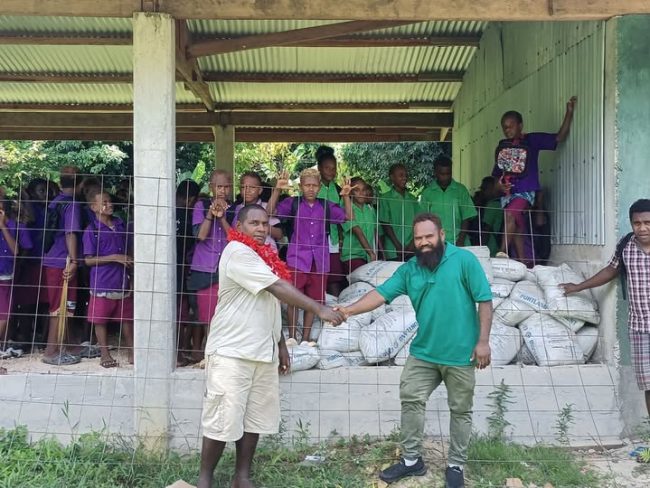 Community Development Officer (CDO) of North Malaita Constituency right hands over building materials to Kafoasila Community High School last week.